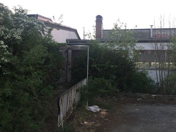 Abandoned building in city against clear sky