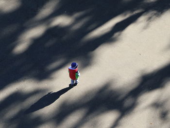 High angle view of child on shadow