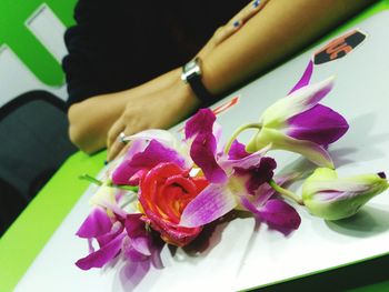 High angle view of woman holding bouquet of pink flower