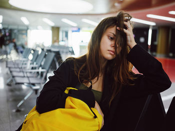 Tired woman sitting at airport