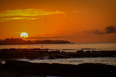 Scenic view of sea at sunset