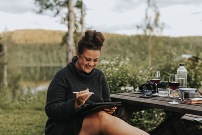 Woman using digital tablet in garden