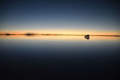Scenic view of sea against clear sky during sunset