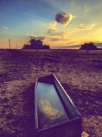 Scenic view of field against sky during sunset