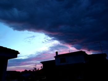 Low angle view of buildings against sky at sunset