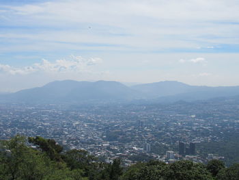 Scenic view of city and buildings against sky