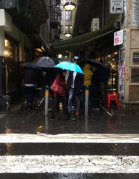 People walking on sidewalk in city