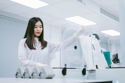 Young female scientist working in laboratory