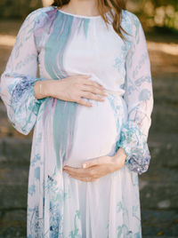 Midsection of woman standing against blurred background