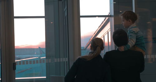 People standing by window