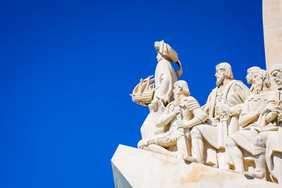 Low angle view of statue against clear blue sky