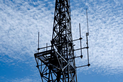 Low angle view of communications tower against sky