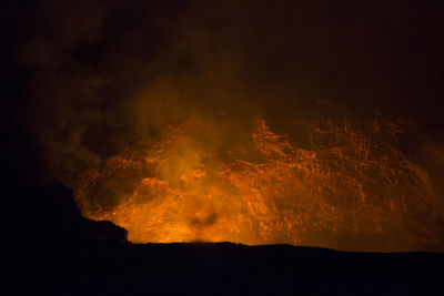Scenic view of mountain against sky at night