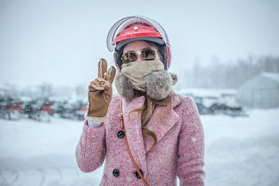 Close-up of smiling girl standing on snow