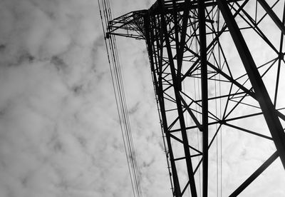 Low angle view of electricity pylon against sky