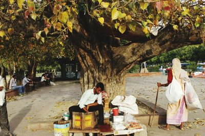 People on sidewalk against trees