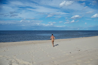 Woman on beach against sky