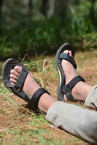 Low section of man relaxing on field