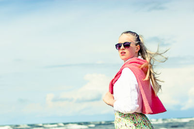 Portrait of woman wearing sunglasses at beach