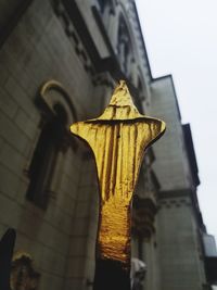 Low angle view of sculptures on building against sky