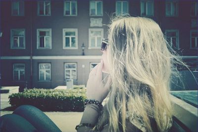 Woman sitting in front of window