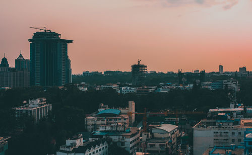 High angle view of buildings in city during sunset