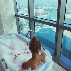 High angle view of woman sitting in bathroom