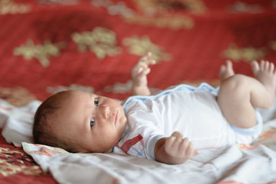 Cute baby lying on bed