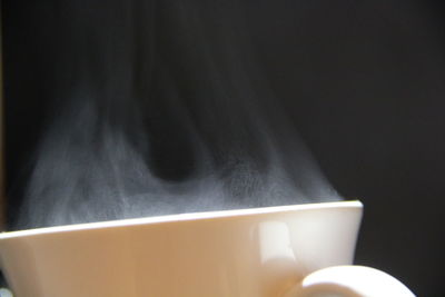 Close-up of coffee cup against black background