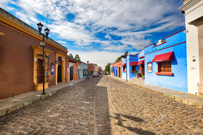 Empty alley amidst buildings in city