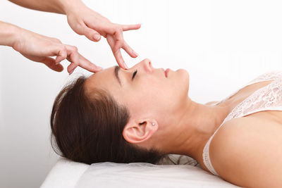 Portrait of young woman lying on bed