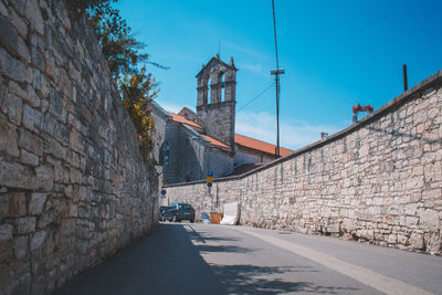 Street amidst buildings against sky