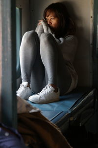 Woman sitting on train looking out the window