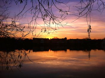 Scenic view of lake against orange sky