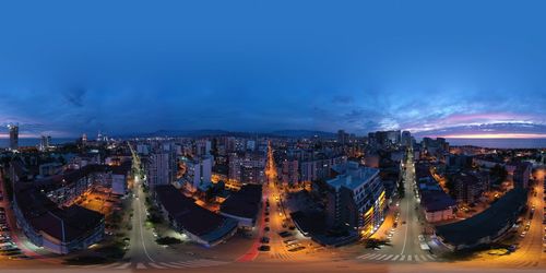 High angle view of city lit up at night