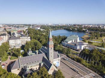 High angle view of buildings by river against clear sky