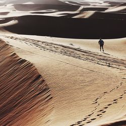 Man walking on sand