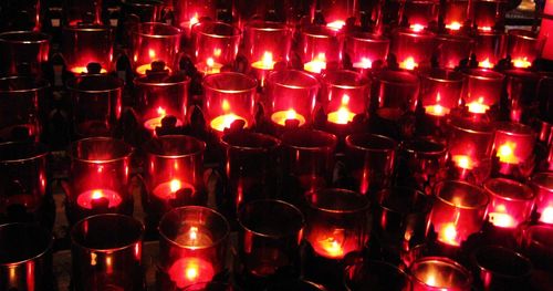 Close-up of tea light candles in temple