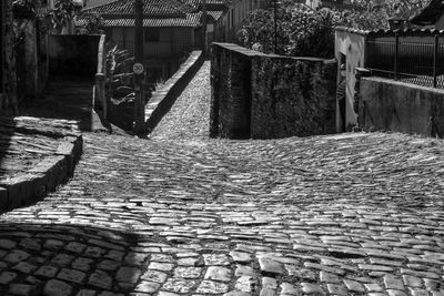 Cobblestone street amidst buildings in city