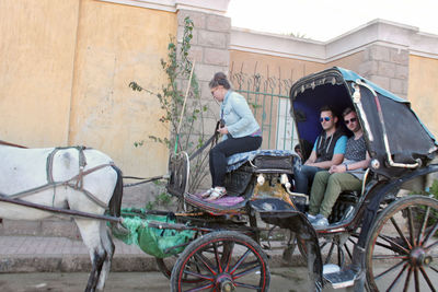 Friends sitting in horse cart