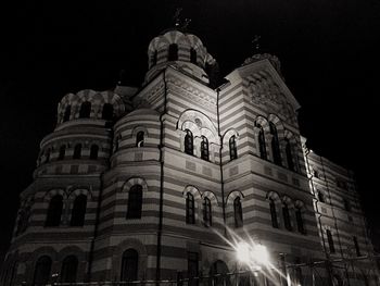 Low angle view of illuminated building against sky at night