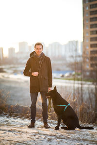 Full length of man standing with dog