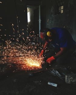 Man working on metal in factory