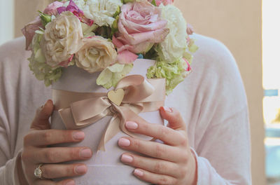 Close-up of hand holding rose bouquet
