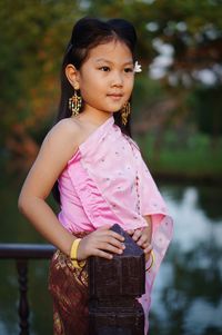 Portrait of a smiling girl holding outdoors