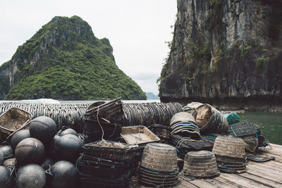 Baskets and buoys on pier at halong bay