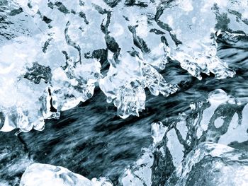 Close-up of frozen sea against rocks