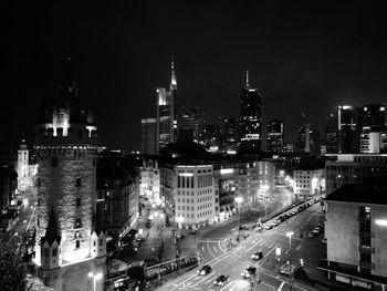 Illuminated buildings in city against sky at night