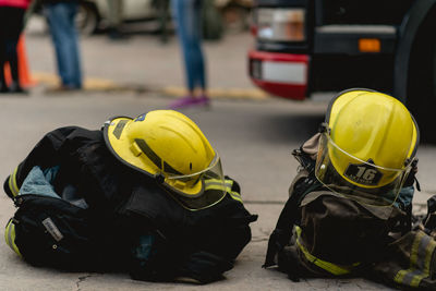 Close-up of firefighter uniforms on sidewalk