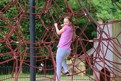 Rear view of girl playing at playground